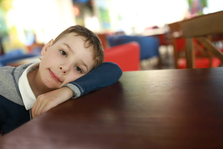 Portrait of a pensive boy in cafe