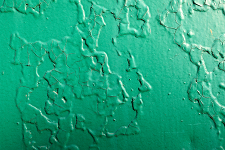 Green wall with shabby paint as backgroundの写真素材