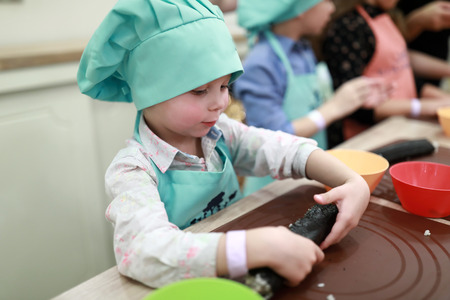 Children preparing sushi rolls at cooking classの写真素材