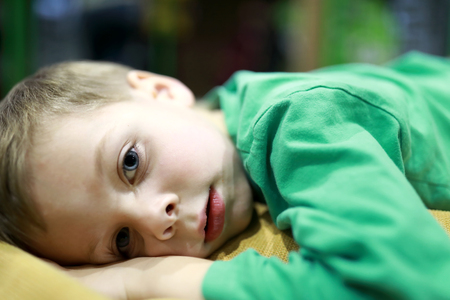 Child lying on the sofa at homeの写真素材