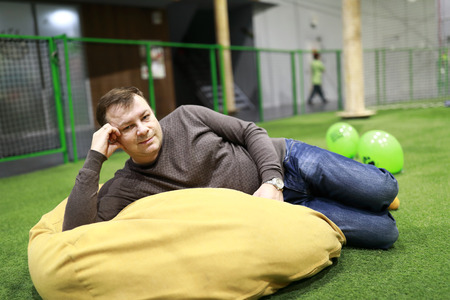 Man resting on bean bag chair indoor