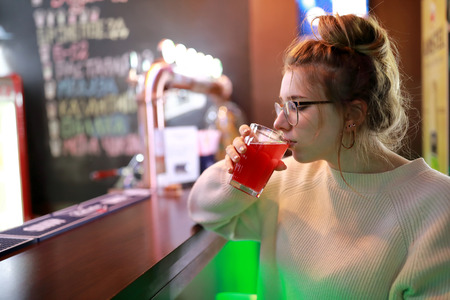 Girl sitting at bar in a restaurantの写真素材