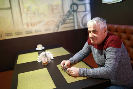 Portrait of elderly man in a restaurantの写真素材
