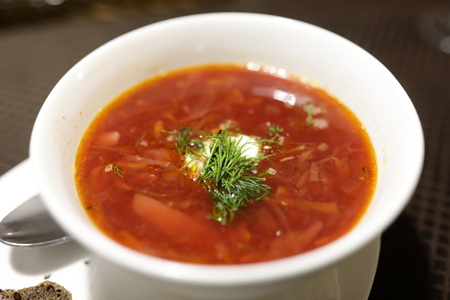 Plate of borsch on table in a restaurant