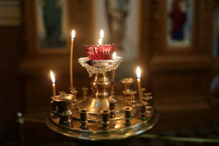 Candlestick with burning candles in orthodox churchの写真素材