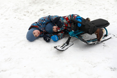Children fell from snow scooter in winter