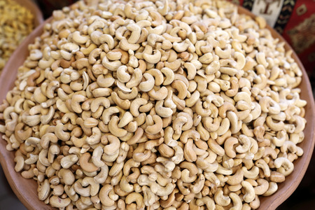 Plate of cashew nuts on counter in marketの写真素材