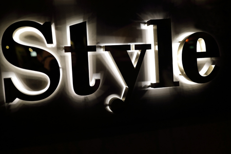 Details of style sign on wall at nightの写真素材