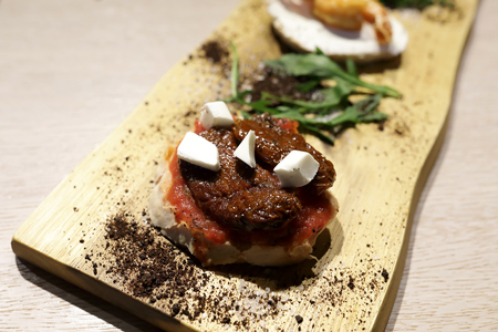 Bruschetta with tomato paste and mozzarella in restaurant