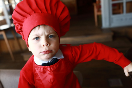 Portrait of boy in red cap cookの写真素材