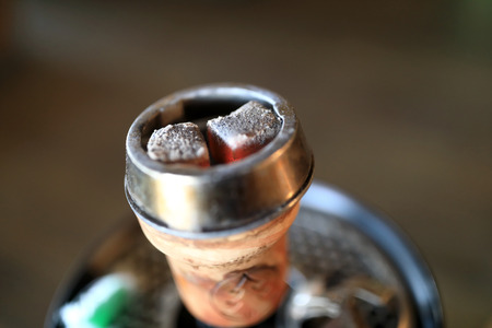 Details of hookah coals on brown background