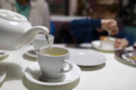 Person pouring green tea in a cafe