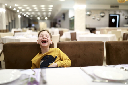 Portrait of laughing boy in the restaurantの写真素材