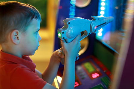 Boy shoots pistol in an amusement center