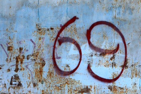 View of sixty nine sign on wallの写真素材