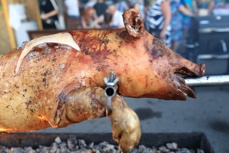 Roasting pig on spit on the streetの写真素材