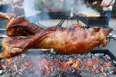 Cooking piglet on spit on the streetの写真素材