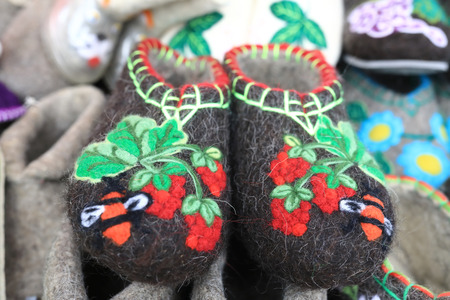 Embroidered felt slippers on the market counter