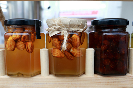 Nuts in Honey and Jam in glass jarsの写真素材