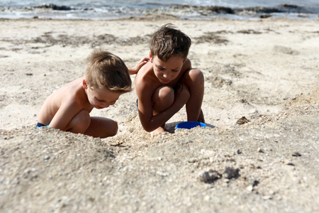 Brothers playing on beach of Sea of Azovの写真素材