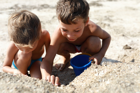 Children playing on beach of Sea of Azovの写真素材