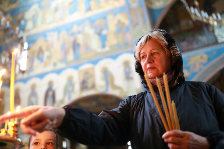 Portrait of senior woman in orthodox churchの写真素材