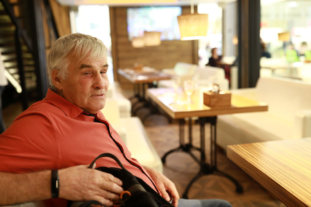 Portrait of senior man in a restaurantの写真素材