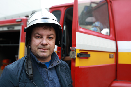 Portrait of fireman near a fire truck