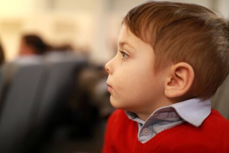 Serious kid watching a performance in a theaterの写真素材