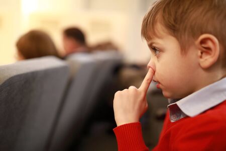 Child picks his nose in the theater
