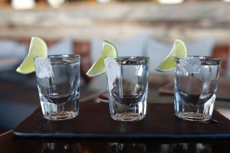 Three glasses of tequila on plate in restaurantの写真素材