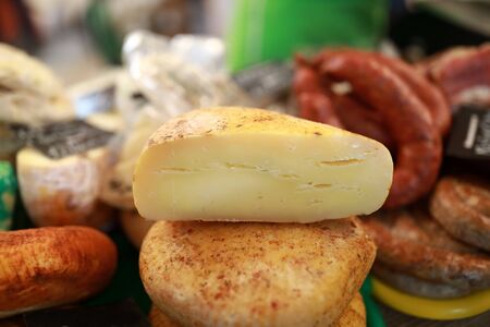 Piece of cheese on counter in marketの写真素材