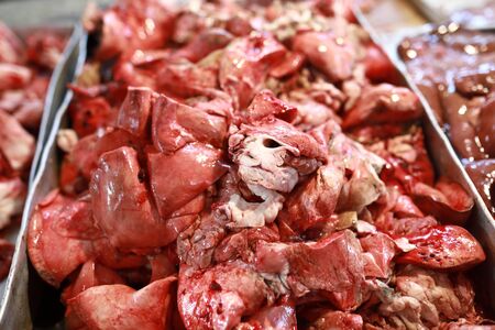 Pieces of lamb meat in tray on marketの写真素材