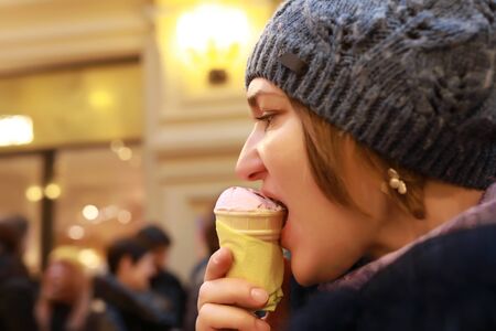 Portrait of woman is eating ice cream