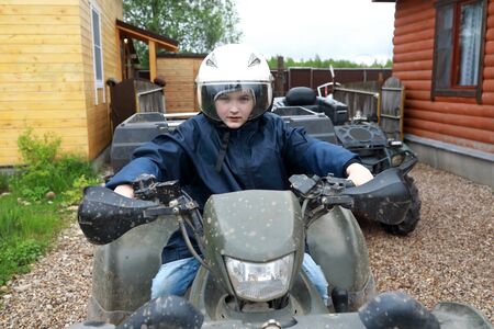 Portrait of boy sitting on quad bike