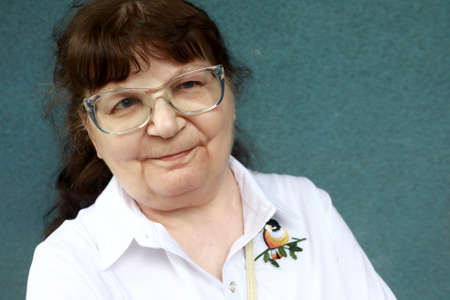 Portrait of senior woman on wall background