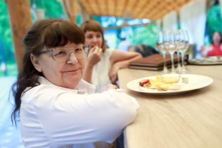Portrait of senior woman at a bar