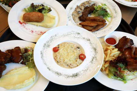 Plates with burgers on tray in restaurantの写真素材