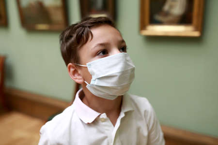 Portrait of kid wearing protection mask in museum