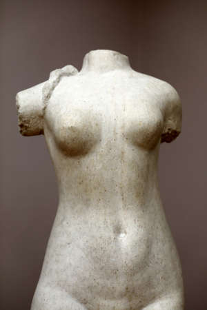 Marble torso of woman on wall background