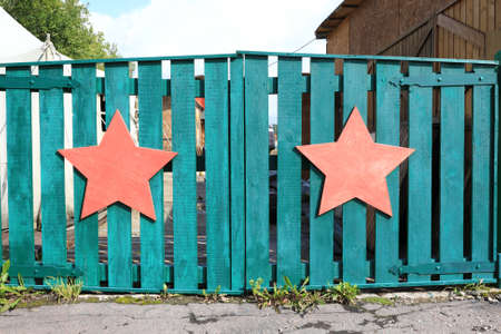 View of wooden gate with red starsの写真素材