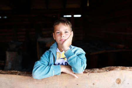 Portrait of serious child in wooden windowの写真素材