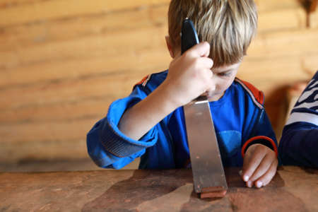 Boy making mascot with runes in workshopの写真素材