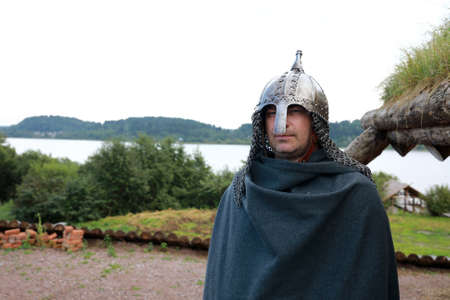 Viking posing on shores of Lake Ladoga in summer, Karelia