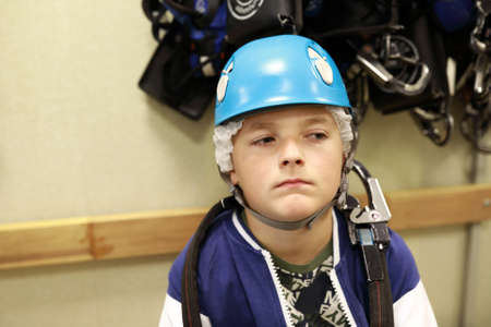 Portrait of child with climbing equipment indoors