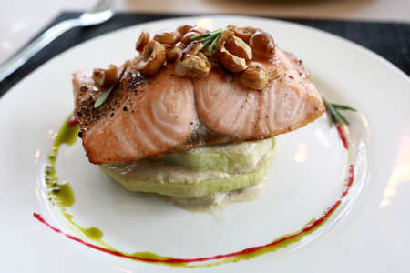 Trout with zucchini on plate in restaurant