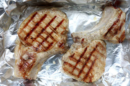 Fried pork loin in grill pan on foil before baking in oven