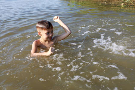 Boy swimming in lake, Krasnodar region, Russiaの写真素材