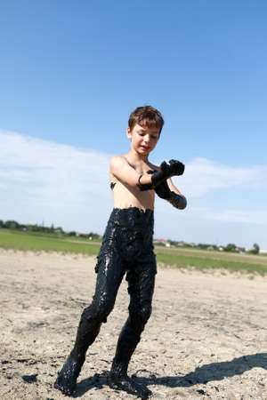 Kid Covered in Medicinal Mud, Krasnodar region, Russiaの写真素材