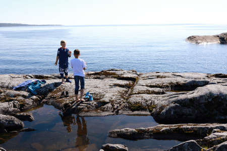 Children on island in lake Ladoga skerries, Kareliaの写真素材